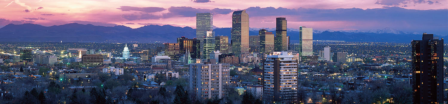 Image of Denver, Colorado at night, ranging from our beautiful mountain ranges to our State Capitol