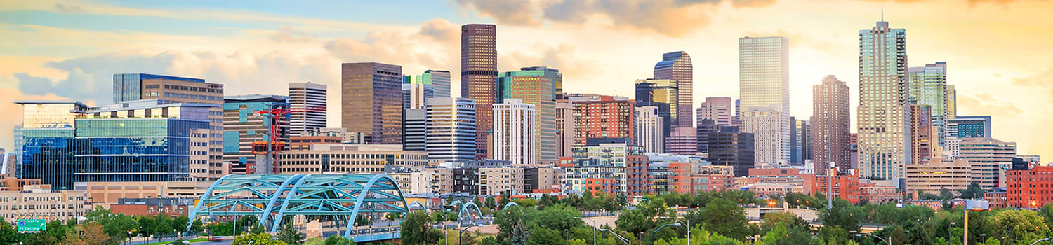 Image of downtown Denver, Colorado, highlighting its vibrant energy and colorful aesthetic at sunset