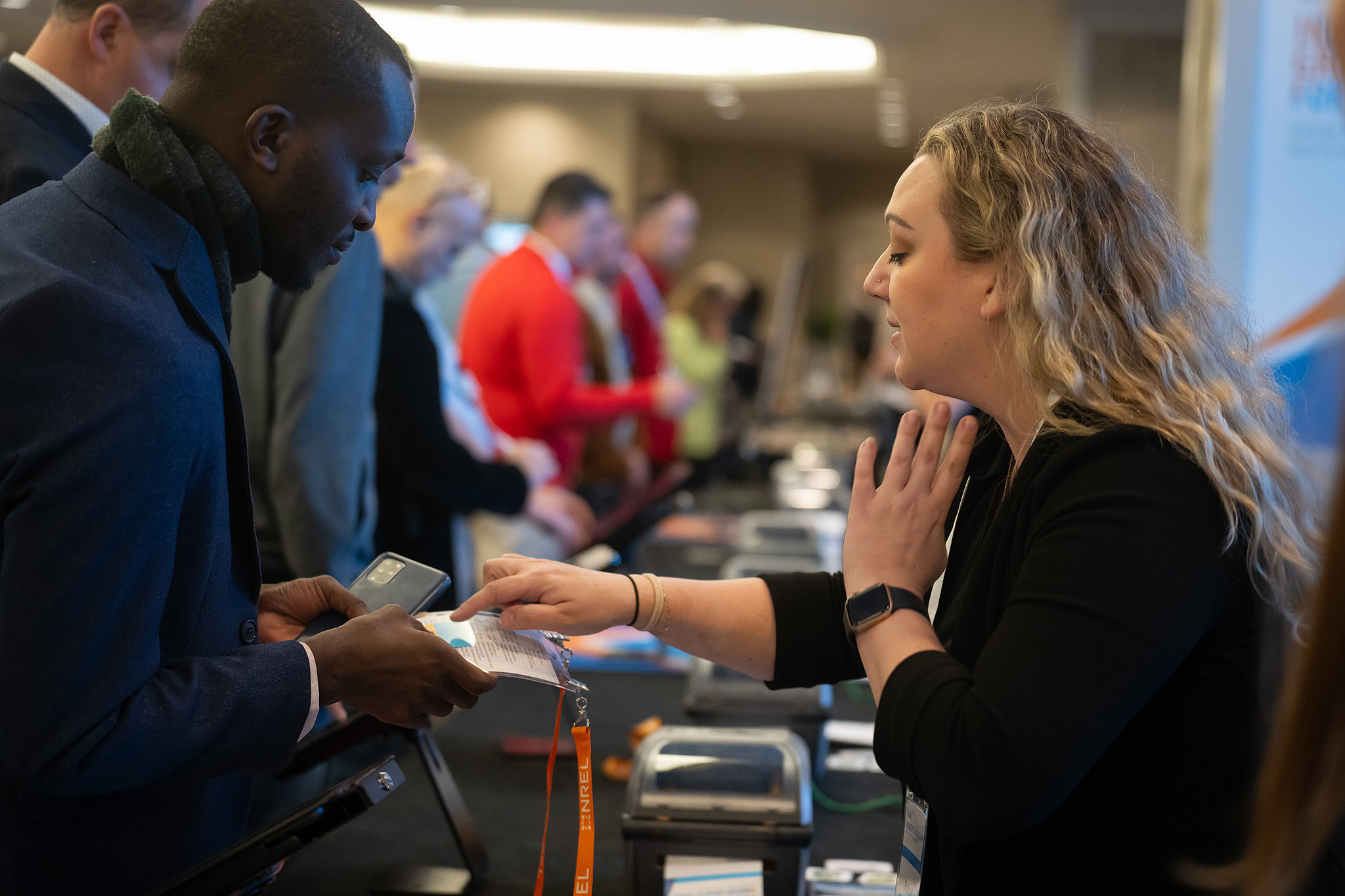 woman hands man badge