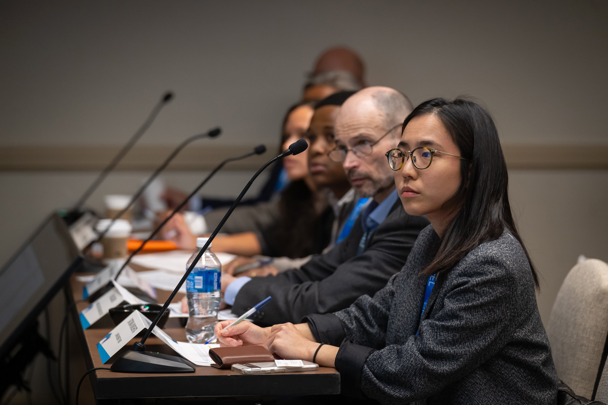 Row of four people listening to presentation